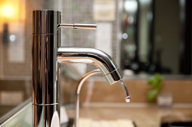 Leaking tap being repaired in West Ealing